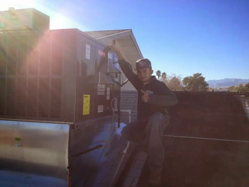 HVAC technician performing HVAC Inspection on a rooftop unit in Sapulpa